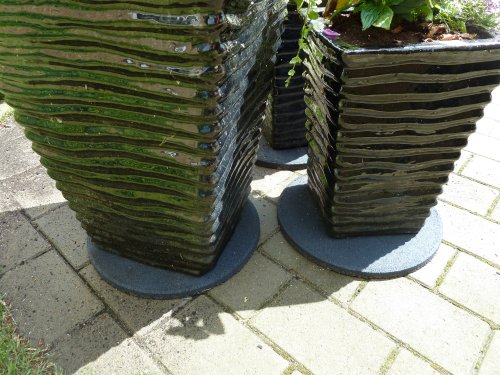 Rubber stepping stones under flower pots